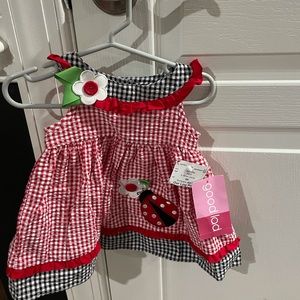 Brand new dress with diaper cover. Tags on
